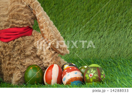 Rabbit, sit on green grass and group of colorful eggs are behind Rabbit, sit on green grass and group of colorful eggs are behind 14288033