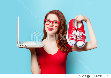 Style redhead girl with gumshoes and laptop 14294694