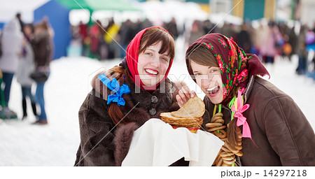 girl tasting pancake during Shrovetide 14297218