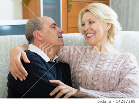 Couple pensioners together on sofa at home Couple pensioners together on sofa at home 14297389