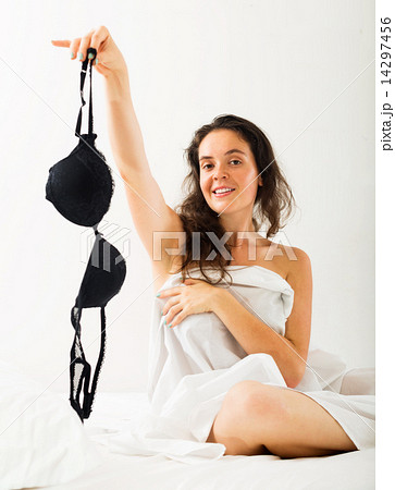 Girl takes off underwear on bed 14297456