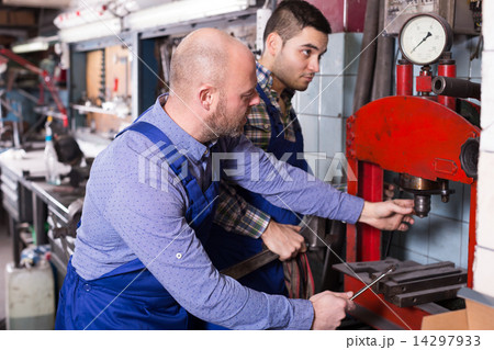 Mechanics working at workshop 14297933
