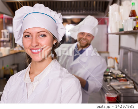 Chef and his helper at bistro kitchen Chef and his helper at bistro kitchen 14297935