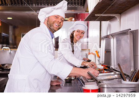 Chef and his helper at bistro kitchen Chef and his helper at bistro kitchen 14297959