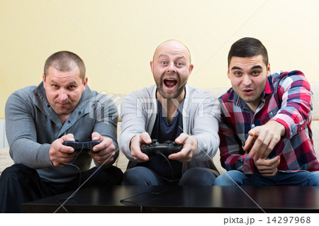 Three friends playing video games 14297968