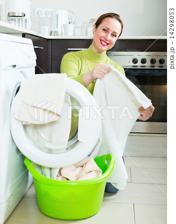 Happy woman near washing machine Happy woman near washing machine 14298053