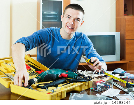 Happy guy with tools in toolbox at home Happy guy with tools in toolbox at home 14298244