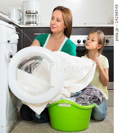 Woman with daughter near washing machine 14298549