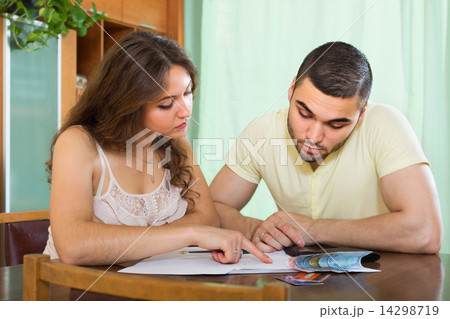 Couple with money and documents Couple with money and documents 14298719