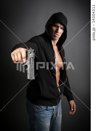 man shooting gun isolated on gray background. focus on gun 14304311