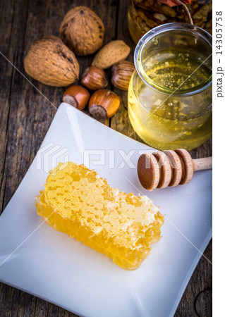 honey dipper and honeycomb, nuts of various kinds 14305758