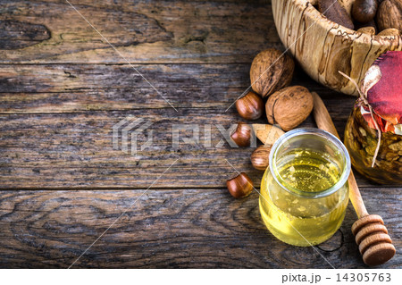 honey dipper and nuts in honey and nuts of various kinds, 14305763