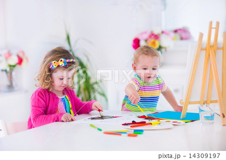 Children paiting on wooden easel Children paiting on wooden easel 14309197
