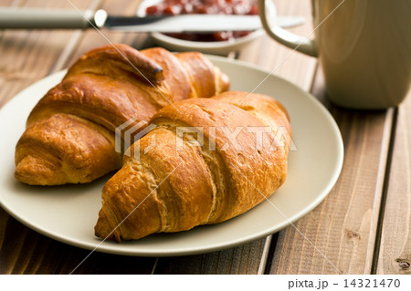 two croissants on wooden table two croissants on wooden table 14321470