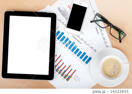 Coffee cup, tablet over papers with numbers and charts Coffee cup, tablet over papers with numbers and charts 14322655