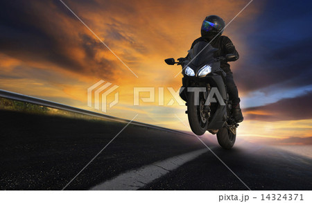 young man riding motorcycle on asphalt highways road with profes young man riding motorcycle on asphalt highways road with profes 14324371