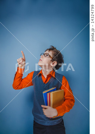 European-looking boy of ten years in glasses with a book showing 14324799