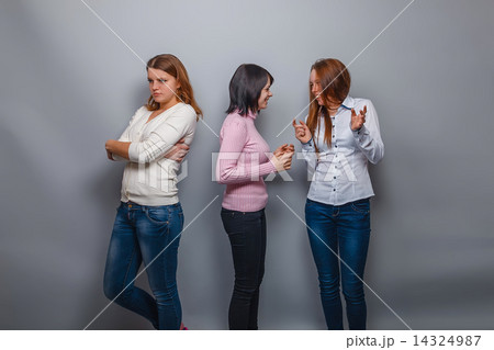 two girls talking European appearance and ignore the third girlf 14324987