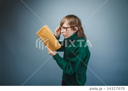 teenager boy brown hair European appearance in green sweater wit 14327070