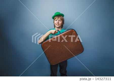 European-looking boy of ten years with a  suitcase in hat  on  14327311