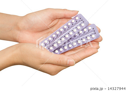 young woman's hand holding birth control pills young woman's hand holding birth control pills 14327944