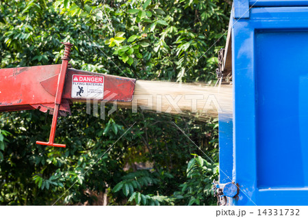 Wood chipper machine releasing the shredded woods into a truck 14331732