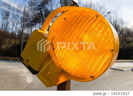 Traffic warning lamp in yellow on a street macro Traffic warning lamp in yellow on a street macro 14337417