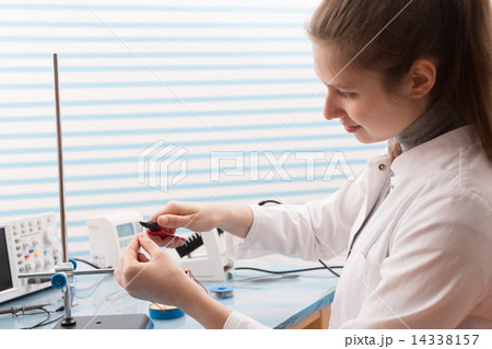 Girl Solder and adjust Electronic Device 14338157