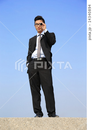 Businessman with telescope looking forward 14340894
