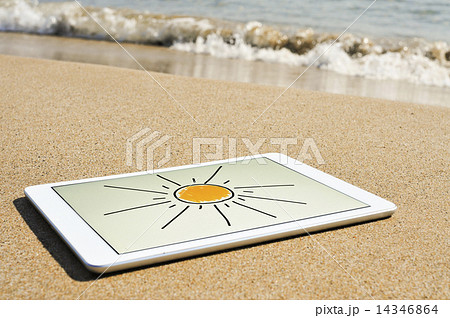 sun drawn in a tablet in the sand of a beach 14346864