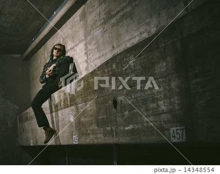 Young man and concrete wall Young man and concrete wall 14348554