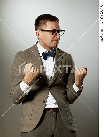Confident nerd in eyeglasses and bow tie enjoying success Confident nerd in eyeglasses and bow tie enjoying success 14351646