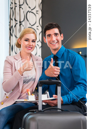 Man and woman arriving in hotel room 14357539