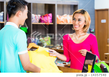 Asian woman paying purchase in fashion store 14357540
