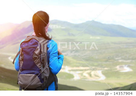 cheering hiking woman enjoy the beautiful view at mountain peak in tibet,china cheering hiking woman enjoy the beautiful view at mountain peak in tibet,china 14357904