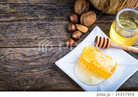 honey dipper and honeycomb, nuts of various kinds 14357950