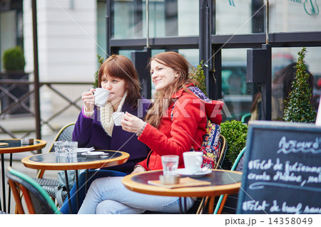 Two cheerful young girls in a Parisian street cafe Two cheerful young girls in a Parisian street cafe 14358049
