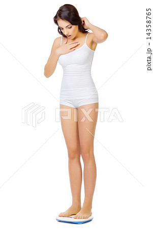 Young healthy girl on home scales Young healthy girl on home scales 14358765