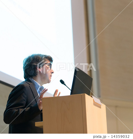 Speaker giving talk on podium at Business Conference. Speaker giving talk on podium at Business Conference. 14359032