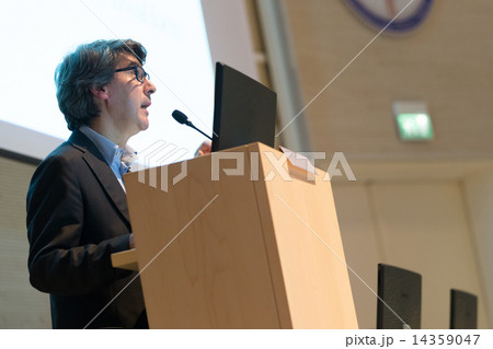 Speaker giving talk on podium at Business Conference. Speaker giving talk on podium at Business Conference. 14359047