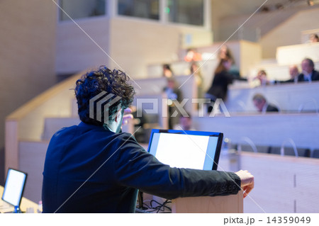 Speaker giving talk on podium at Business Conference. Speaker giving talk on podium at Business Conference. 14359049