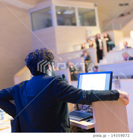 Speaker giving talk on podium at Business Conference. Speaker giving talk on podium at Business Conference. 14359072