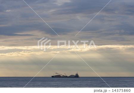 cargo ship loaded with stones at sunset 14375860