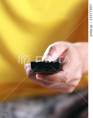 Hand pressing remote control Hand pressing remote control 14377897