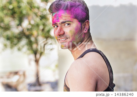 Portrait of Indian guy with colorful paint on face 14386240