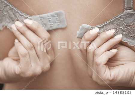Woman undressing brassiere 14388132