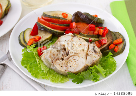 boiled fish with vegetables on the plate 14388699