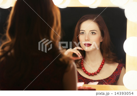 beautiful woman is applying makeup beautiful woman is applying makeup 14393054