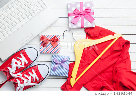 White computer and gumshoes with clothes 14393644