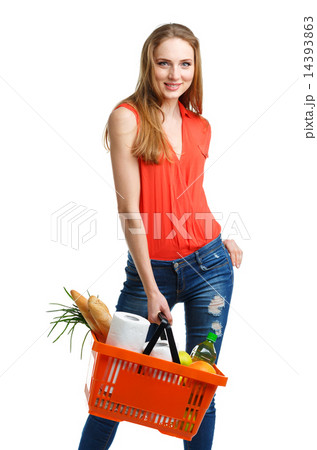 Woman with assorted grocery products in basket Woman with assorted grocery products in basket 14393863
